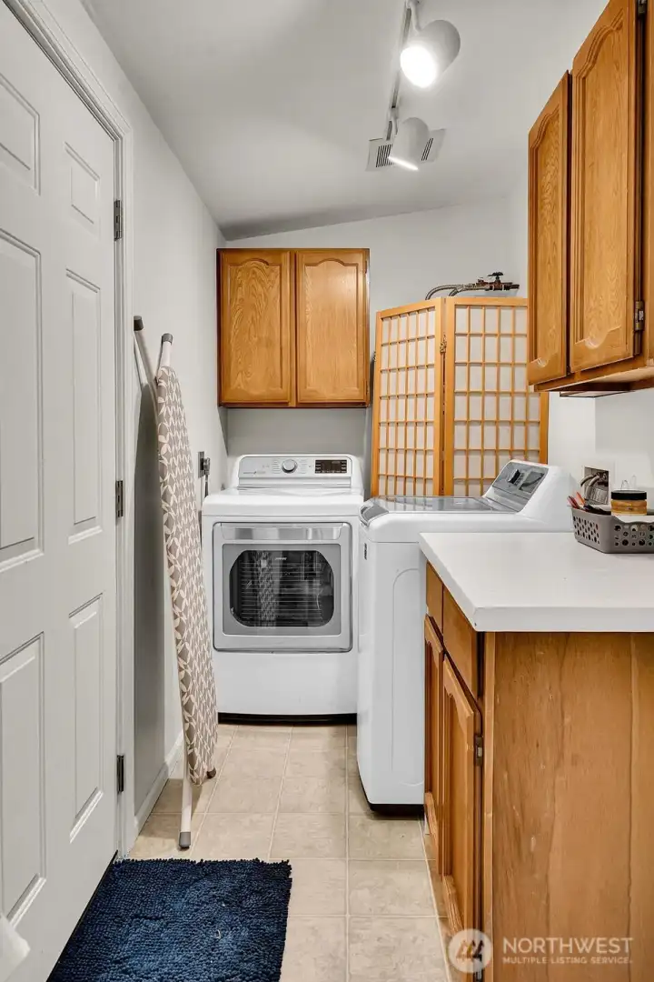 Laundry with back door that leads to garage and back yard.