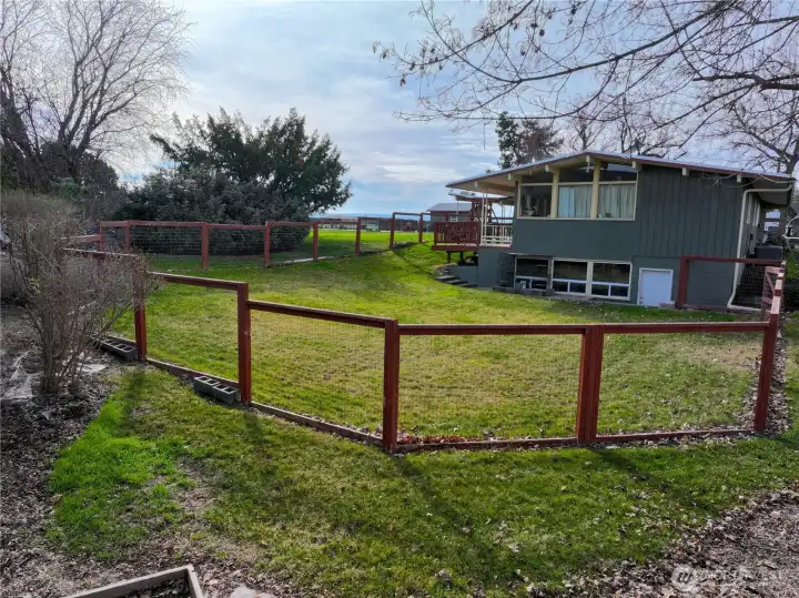 Partially fenced area to the East of the home