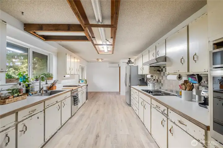 Massive kitchen with distressed original wood cabinets, updated smart appliances