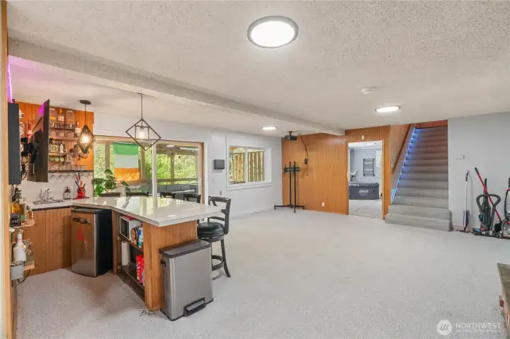 Lower level bar area with 2nd living room, opens to decks behind home