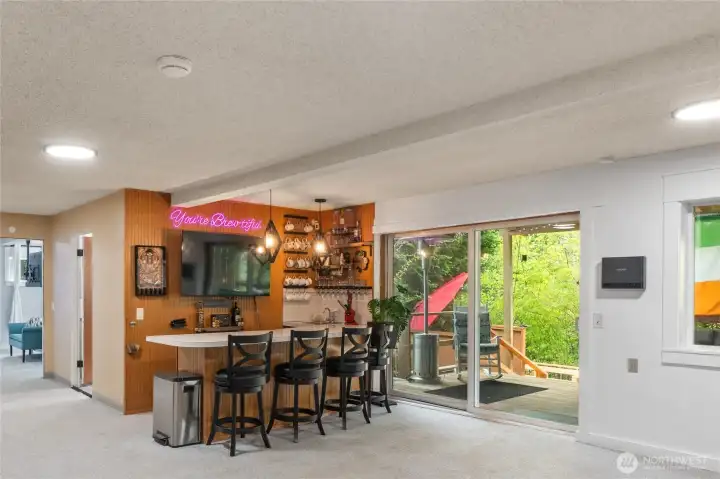 Bar area with sink & mini fridge, sliders to back deck