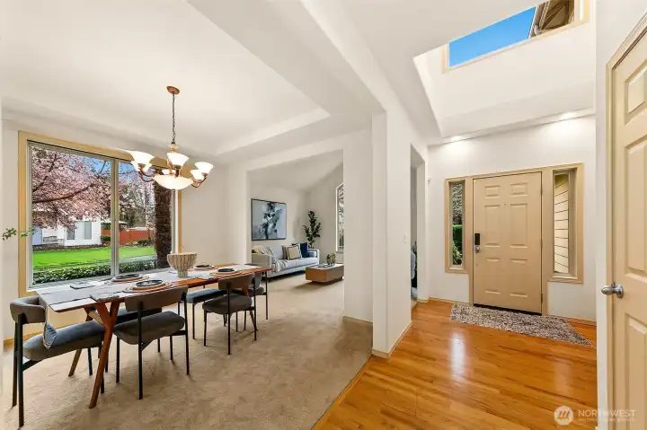 Step into a dramatic double-height foyer where soaring ceilings and clerestory windows introduce the home’s signature light and openness.