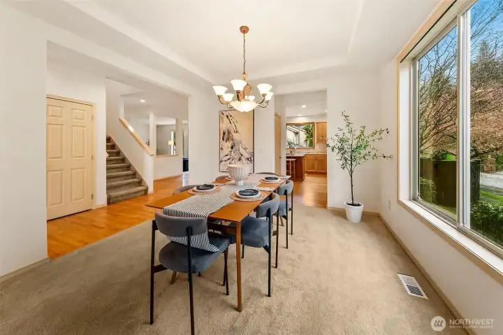 Natural light guides the transition between living and dining spaces, reinforcing a layout designed for connection and ease.