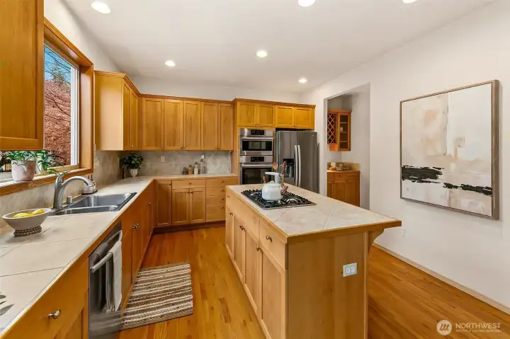 Seamless connection between kitchen, dining, and outdoor spaces creates an intuitive flow for entertaining and daily living.