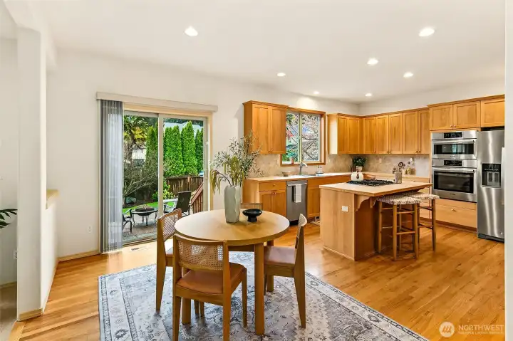 Dining area positioned for both formal gatherings and casual meals, with direct access to the outdoor living spaces.