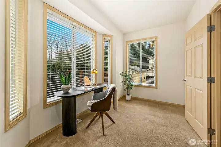 Wide glazed doors and expansive windows bring the outdoors in, reinforcing the home’s connection to its landscaped surroundings.