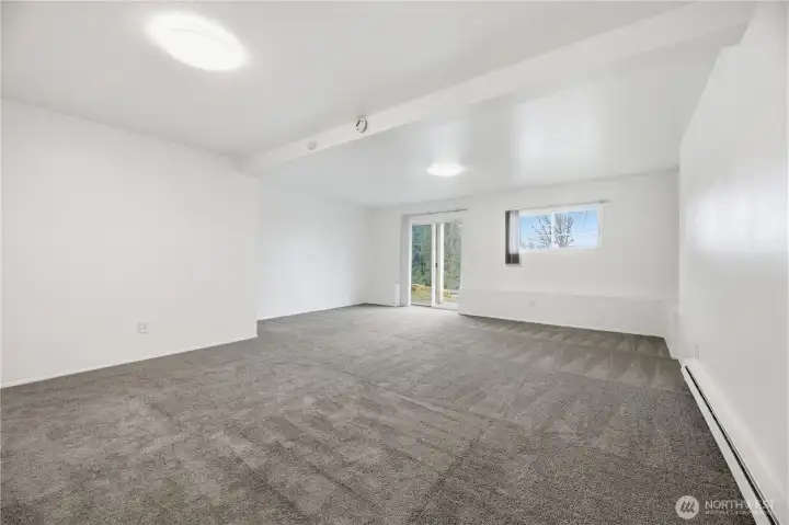 Large downstairs bedroom offers versatility with direct access to the backyard space.