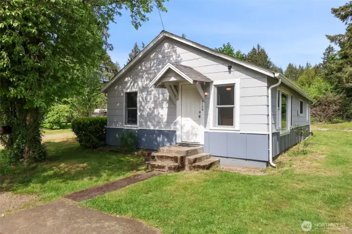 Darling corner lot home with cirular driveway.