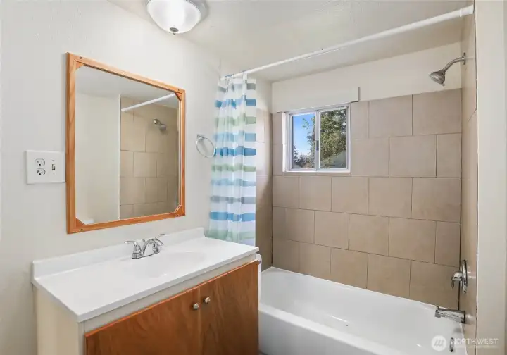 Large bathroom with tub and shower.