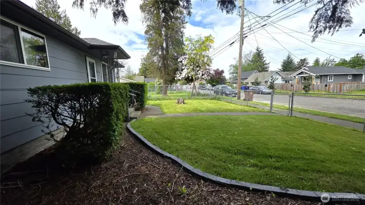 Brick-lined garden accents this well-kept yard