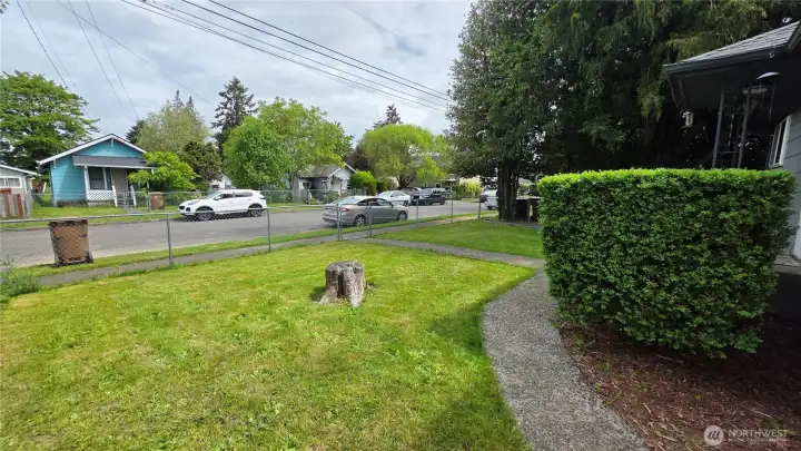 Nice cement path leads from front sidewalk around to the gated side yard.