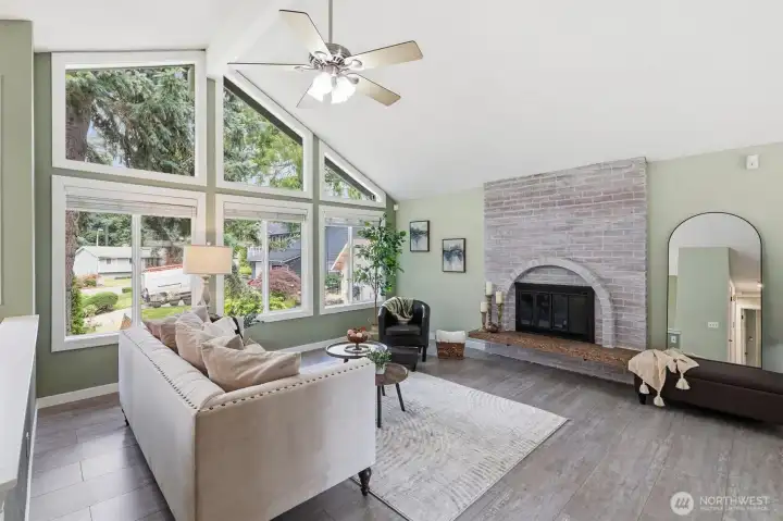 Letting nature in with the lovely high ceilings and big windows.  Enjoy cool evenings by the fire!
