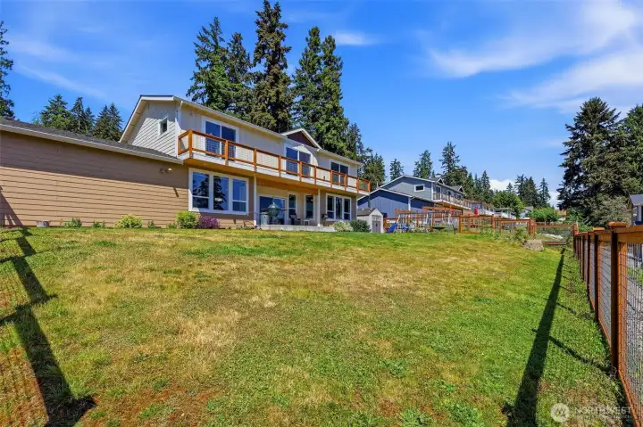Fully-fenced backyard, outdoor shed plus space for gardening, entertaining, and a play area with rubber mulch. Fully-fenced backyard, outdoor shed plus space for gardening, entertaining, and a play area with rubber mulch.