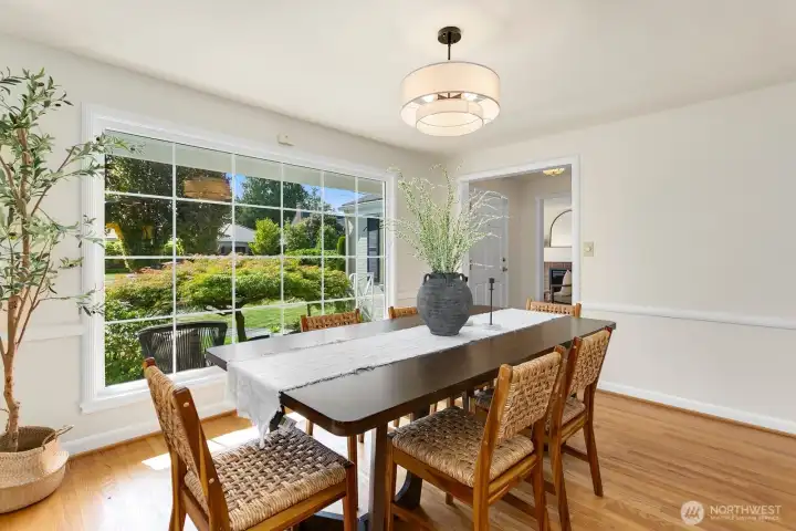 Formal dining room accommodates a large table and overlooks the greenery in the front yard.