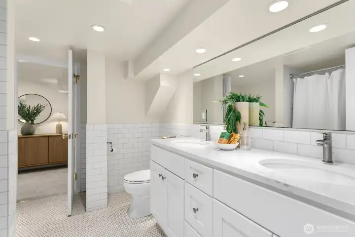 Full bathroom (en-suite too!) for the lower level. The shared access door to the hallway is just behind this photo. Door pictured is to the bedroom.