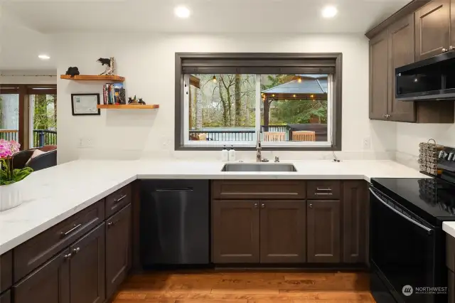 Quartz countertops and stainless steel appliances.