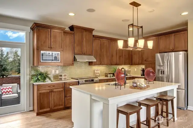 The open-concept kitchen provides the ideal space for entertaining. Photo for illustration purposes only & not of actual home available for sale. The Elm design by Toll Brothers built in a previous community.