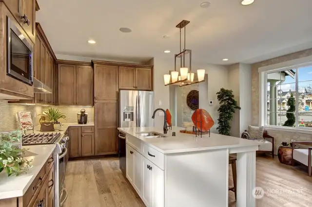 The gourmet kitchen makes a statement with its premium finishes, custom cabinetry, and stainless steel appliances. Photo for illustration purposes only & not of actual home available for sale. The Elm design by Toll Brothers built in a previous community.