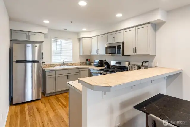 Kitchen with stainless steel appliances and gas range.