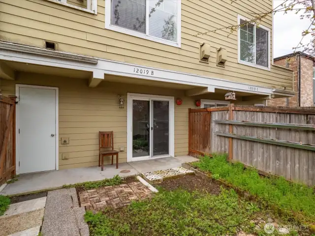 Fenced patio area with garden space.