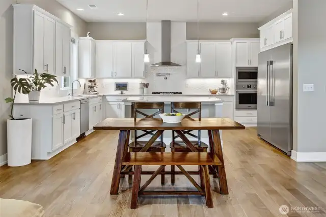 This kitchen is the heart of the home! Massive kitchen features an oversized island with breakfast bar, informal dining space and walk-in pantry. Chef's kitchen includes commercial refrigerator and 5-burner gas range with pot filler and vent hood.