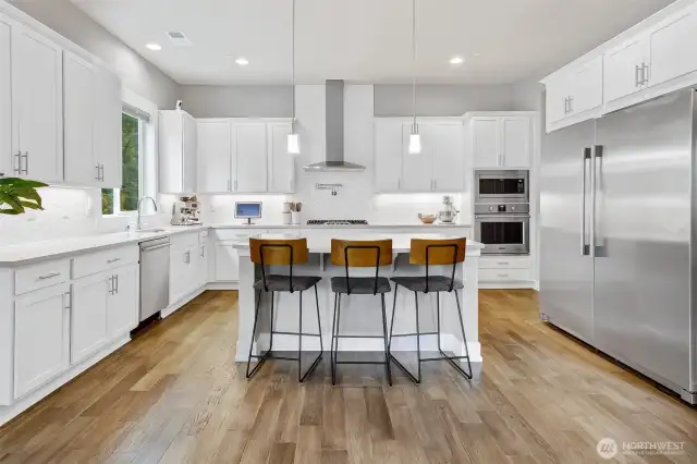 Perfectly appointed kitchen with massive island and breakfast bar. Commercial sized refrigerator and luxury gas range.