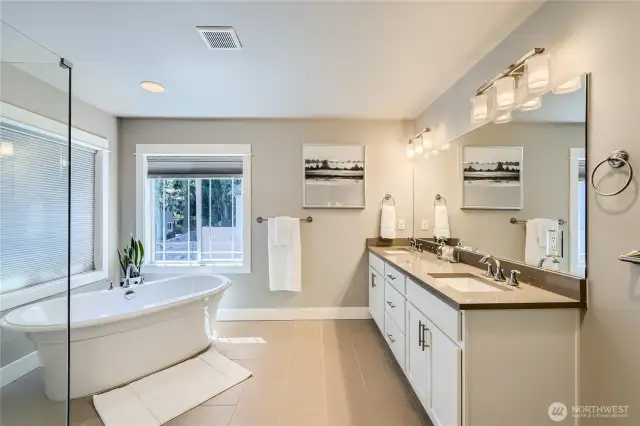 Elegant primary bath with custom, oversized shower and designer stand-alone soaking tub.