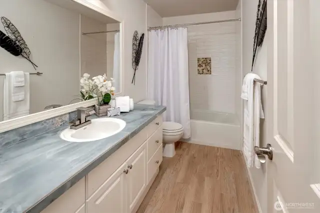 Luxurious renovated bath adorned with Italian porcelain tiles.