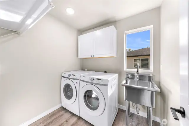 spacious laundry with custom stand alone sink added