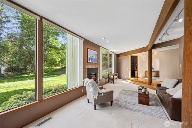 Formal living room features large windows overlooking the spacious lawn.