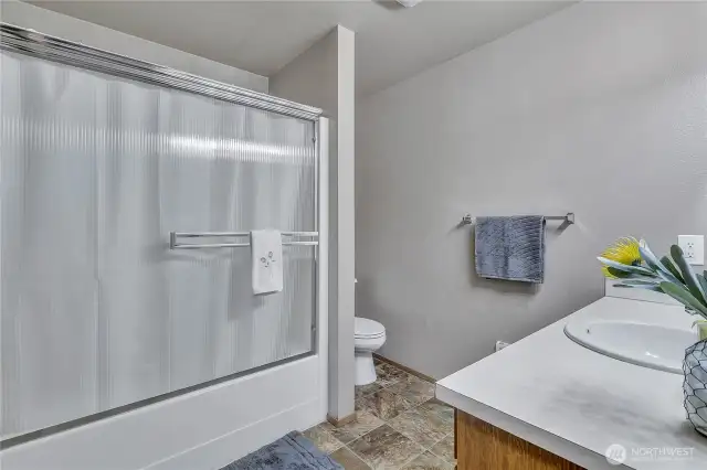Full bath with tub/shower combo.