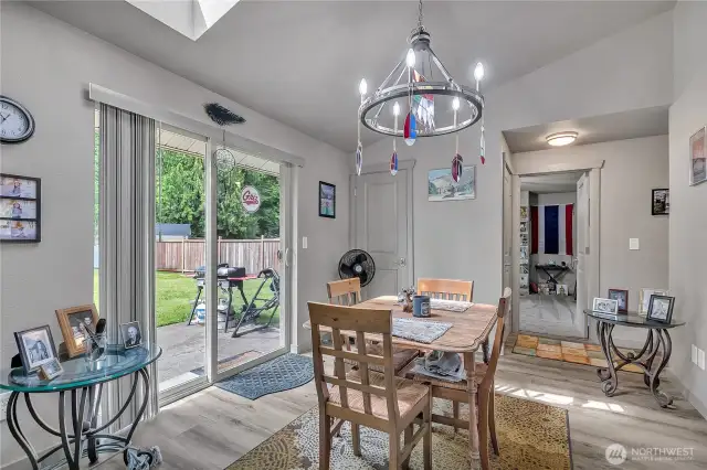 A skylight in the dining room adds natural light, while a slider offers seamless indoor-outdoor living.