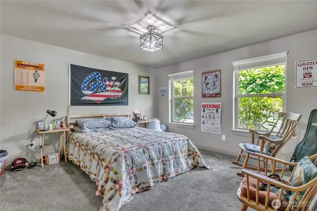 Relax and recharge in the spacious primary bedroom.