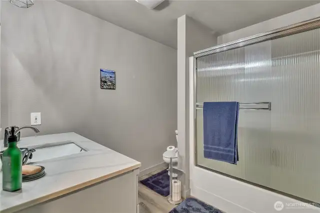 Full bath with tub/shower combo.