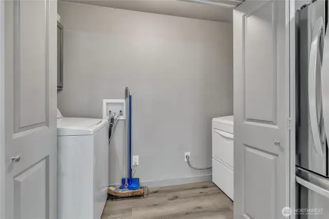 Laundry room with built-in cabinetry.