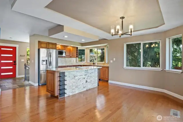 Stunning kitchen and dining area with stainless steel appliances, coffered ceiling, and a refreshed island—truly a showstopper