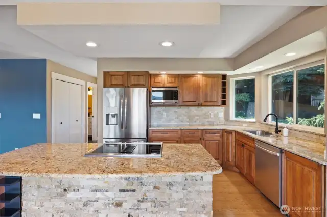 A kitchen with the perfect blend of stone, granite, and tile details