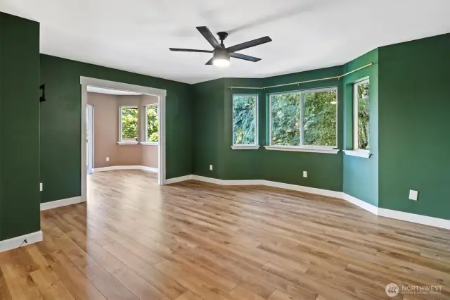 Spacious primary bedroom on the main floor with updated full bath and deck access via slider.