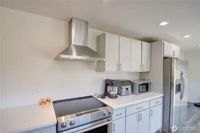 Kitchen has been updated and has quartz counters and stainless appliances.