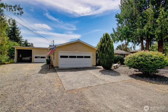 View from driveway of garage and shop