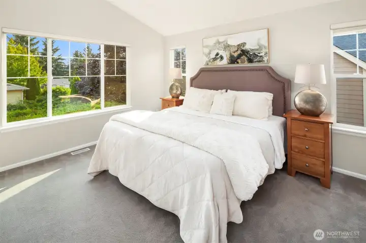 The Primary Suite - light and bright with a vaulted ceiling