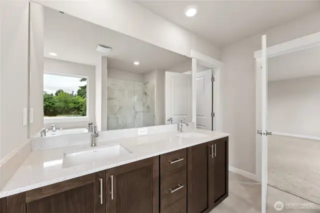 Large double vanity as part of 5-piece primary bathroom with quartz countertops and soft close cabinets. Actual home is under construction and finishes, materials, and colors will vary. See site agent for details.