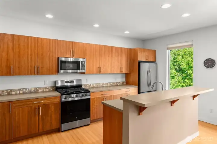 Large kitchen eating bar and open concept. All appliances are included and range and dishwasher are less than two years old.