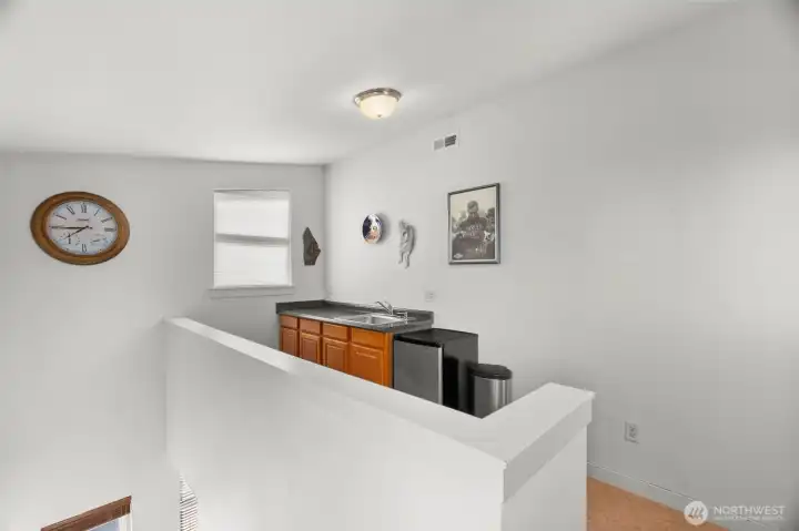 This loft/landing space serves the rooftop deck an is the perfect launching spot for some epic entertaining! Small refrigerator can be included in the sale