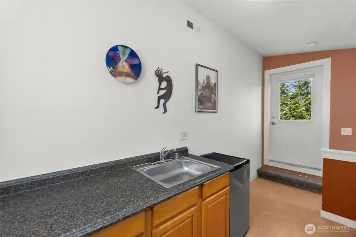 Great prep space, with a sink and storage in the cabinets. Door leads to the deck.