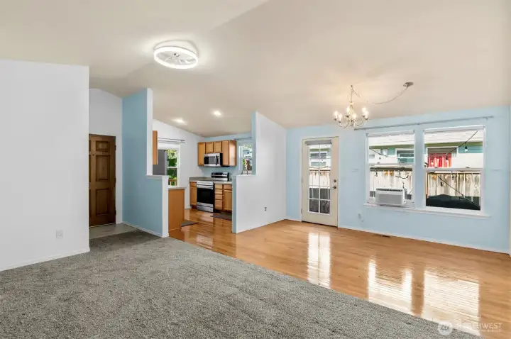 Bright open-concept living room with large windows and abundant natural light.