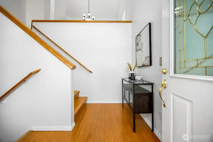 The bright entryway opens to the staircase leading up to the main living level, setting a welcoming tone from the moment you walk in.