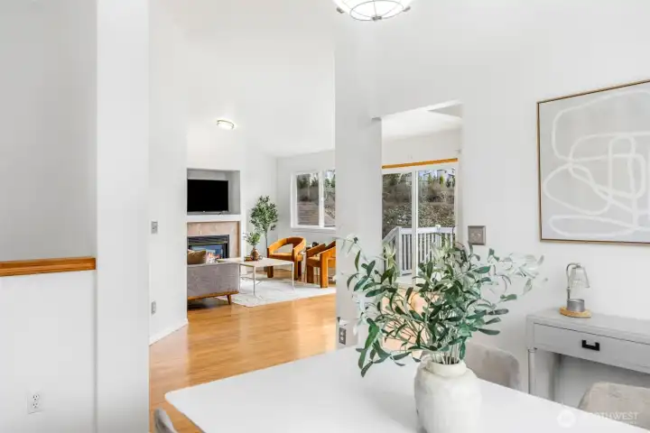 From the dining area, you can see straight through to the living room and out to the deck, showcasing the home's easy flow.