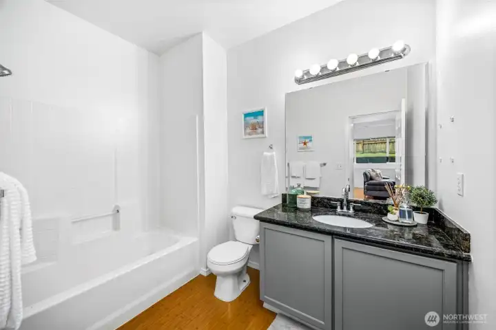 The lower-level full bathroom is fresh and bright with a tub/shower combo.