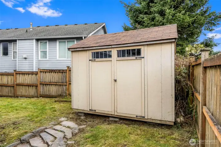 A spacious storage shed in the backyard provides extra room for tools, gear, and outdoor equipment.
